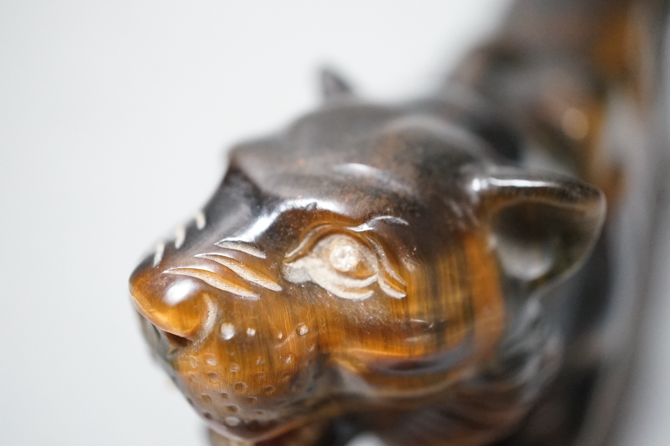 A carved tigers eye model of a tiger with paste set eyes. Makers mark ‘WG’ to paw underside. Numbered 974. 19cm long